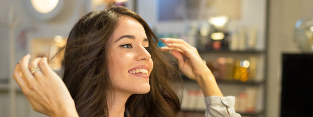 Happy young woman getting new hairstyle in the professional hair salon. - DASHE Beauty Kuwait